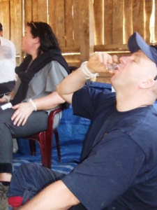 Craig enjoys some home-brew Lao Lao at the village